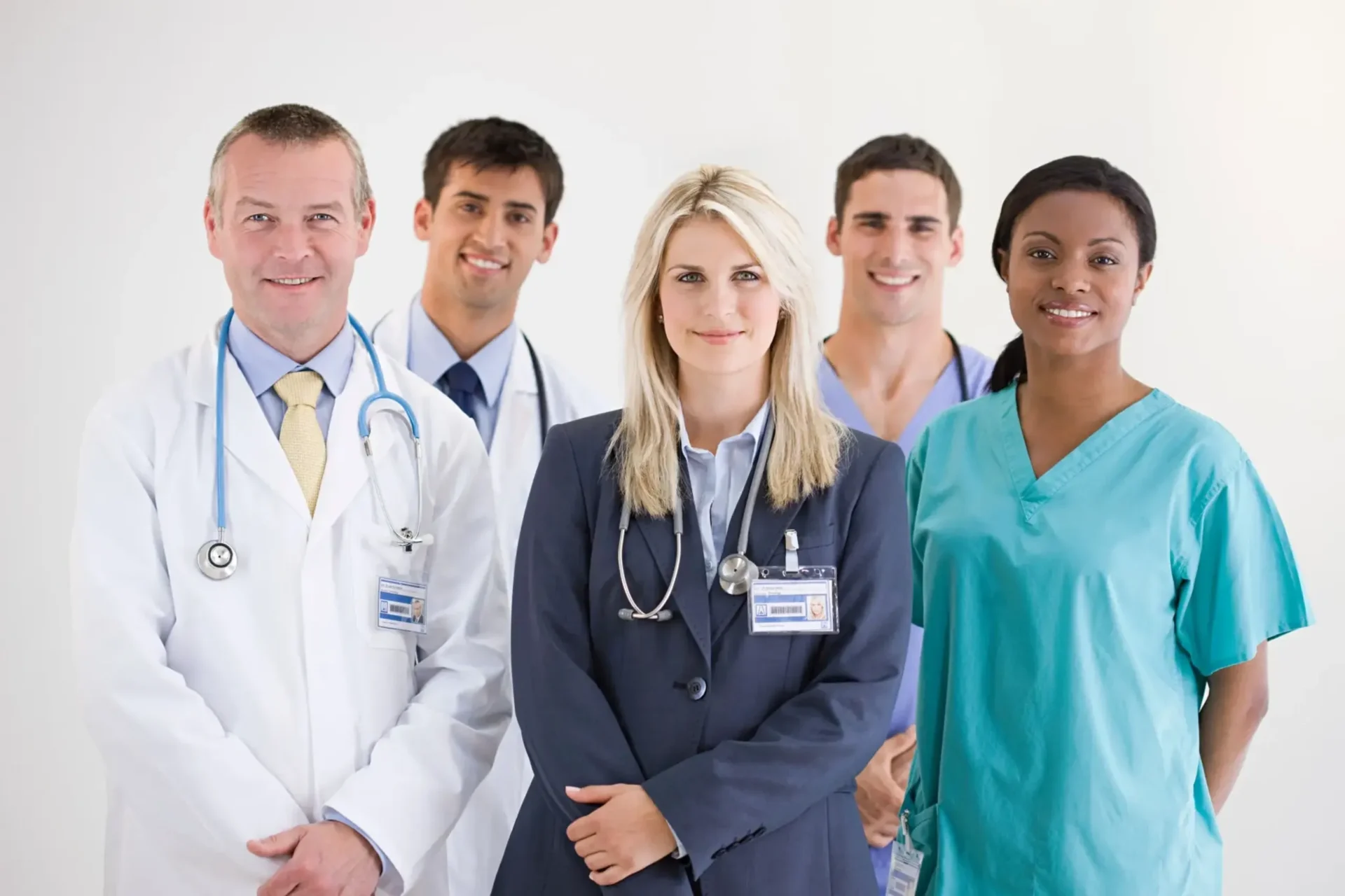 Medical team in professional attire smiling.